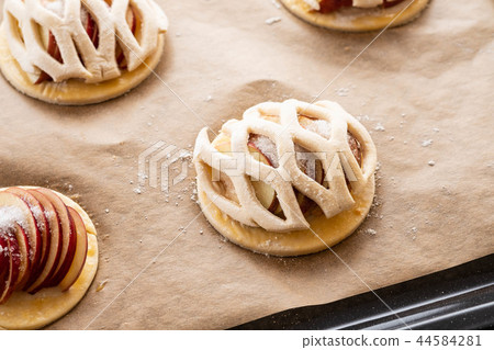 Cooking process of galetta, biscuit with apples on paper background. Apple pie with cinnamon. 44584281
