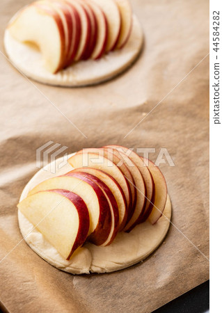 Cooking process of galetta, biscuit with apples on paper background. Apple pie with cinnamon. 44584282