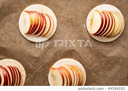 Cooking process of galetta, biscuit with apples on paper background. Apple pie with cinnamon. 44584283
