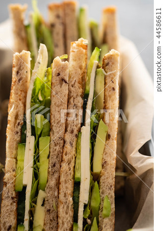 Healthy vegetarian sandwich with arugula, lettuce and avocado, mustard,cucumber. Close-up. Healthy 44586611