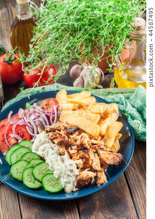 Greek gyros dish with french fries and vegetables 44587495