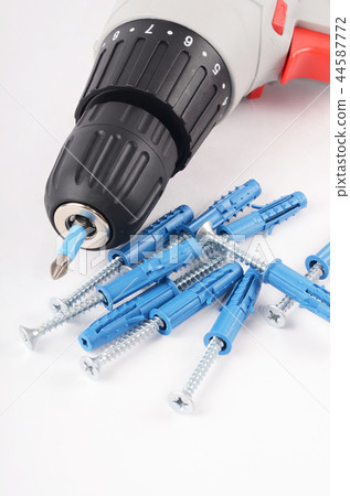 New screwdriver with screws and dowels close-up New screwdriver with screws and dowels close-up 44587772