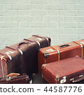 The old suitcases on brick wall background 44587776