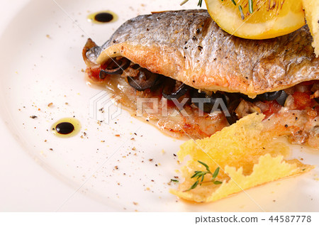 Baked fish stuffed with olives 44587778