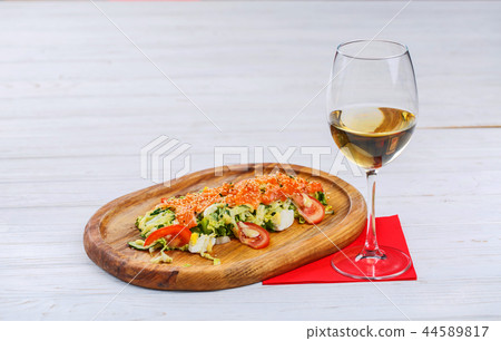 Red fish with sesame on vegetables with a glass of white wine Red fish with sesame on vegetables with a glass of white wine 44589817