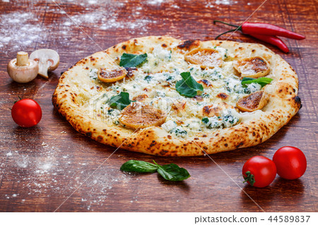 Cheese pizza with mushrooms on a wooden table 44589837