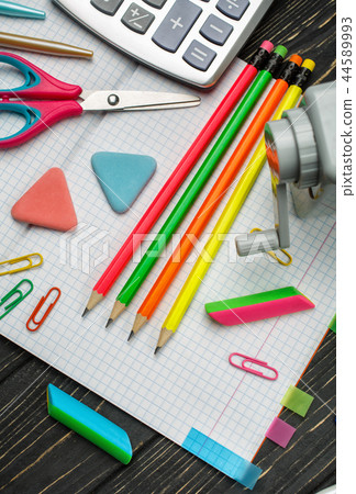 Bright stationery on an open notebook. school background Bright stationery on an open notebook. school background 44589993