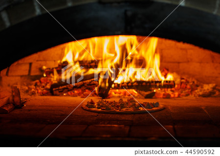 Pizza in the oven at the background of the fire Pizza in the oven at the background of the fire 44590592