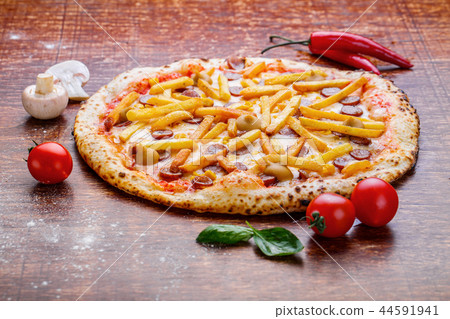 Pizza with french fries and sausage. Appetizing pizza with cheese and potatoes 44591941