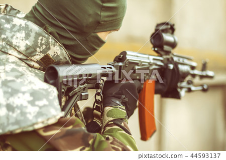 man aiming with an AK-47 man aiming with an AK-47 44593137