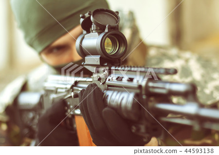 man aiming with an AK-47 man aiming with an AK-47 44593138