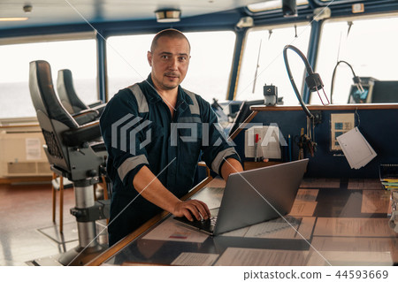 Marine navigational officer is using laptop or notebook at sea 44593669