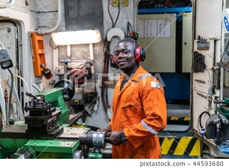 Marine engineer officer working in engine room Marine engineer officer working in engine room 44593680
