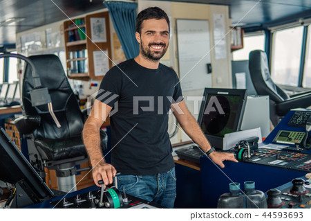 Marine navigational officer is maneuvering ship or vessel Marine navigational officer is maneuvering ship or vessel 44593693