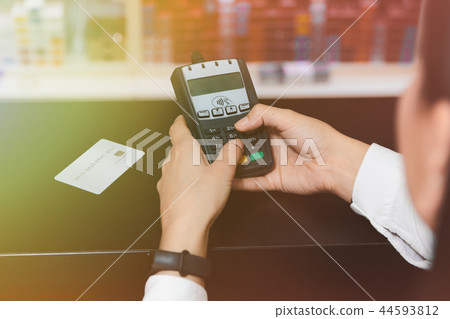 Close up hand of woman's hands inserting pin code on credit card 44593812