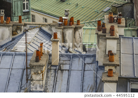 The roofs of Paris and its chimneys under a clouds sky The roofs of Paris and its chimneys under a clouds sky 44595112