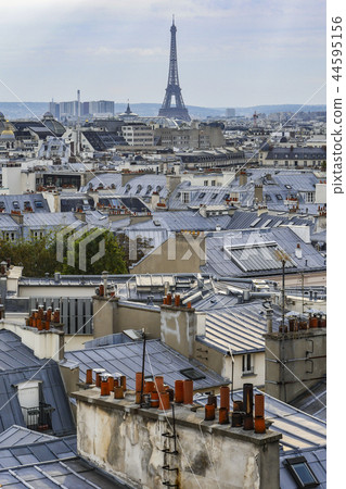 The roofs of Paris and its chimneys under a clouds sky The roofs of Paris and its chimneys under a clouds sky 44595156