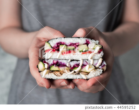 Vegan onigirazu in woman hands Vegan onigirazu in woman hands 44595252