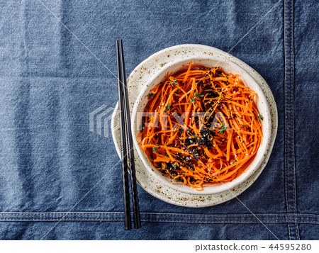 Raw carrot noodles or spaghetti, top view Raw carrot noodles or spaghetti, top view 44595280