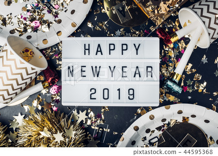 Happy new year 2019 on light box with party item Happy new year 2019 on light box with party item 44595368