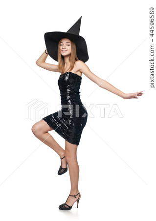 Full length playful Halloween witch on white background 44596589