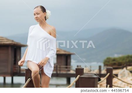 Woman in white blouse on resort Woman in white blouse on resort 44596754