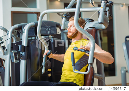 Portrait of a handsome bodybuilder smiling and looking at camera Portrait of a handsome bodybuilder smiling and looking at camera 44596847
