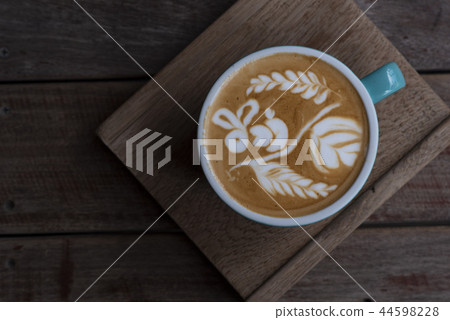 Nice shape of latte art coffee on wooden plate Nice shape of latte art coffee on wooden plate 44598228