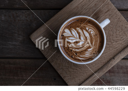 Nice shape of latte art coffee on wooden plate 44598229