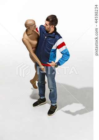 Fashion woman body. The man hugging mannequin, perfect woman dream concept Fashion woman body. The man hugging mannequin, perfect woman dream concept 44598234