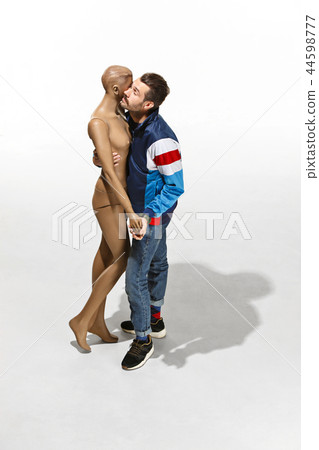 Fashion woman body. The man hugging mannequin, perfect woman dream concept Fashion woman body. The man hugging mannequin, perfect woman dream concept 44598777