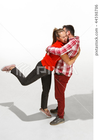 Full body portrait of hugging couple with smile. Caucasian models in love Full body portrait of hugging couple with smile. Caucasian models in love 44598786
