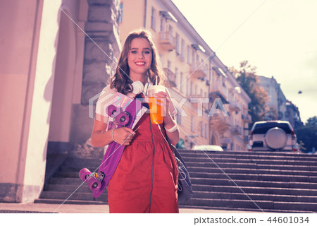 Smiling happy girl on her way home after amazing skateboarding time Smiling happy girl on her way home after amazing skateboarding time 44601034