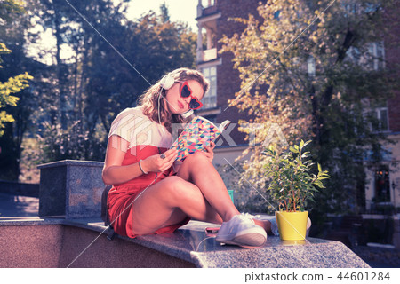 Busy hard-working student checking her notes while preparing for exam outside Busy hard-working student checking her notes while preparing for exam outside 44601284