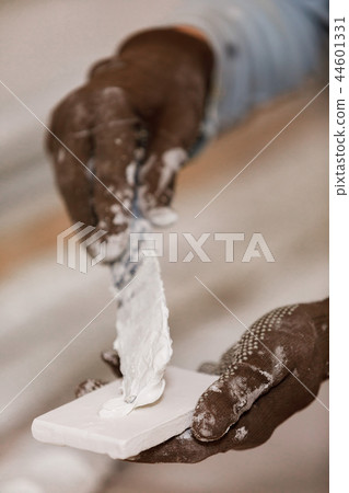 decorative brick with glue before mounting on the wall. 44601331