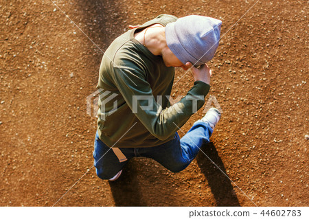Dancer man covers face his hand 44602783