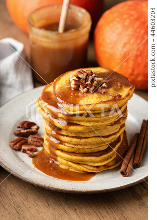 Pumpkin spice pancakes with caramel sauce and nuts 44603203