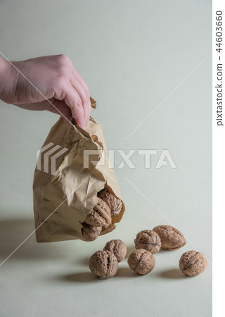 Woman holding a damaged paper bag 44603660
