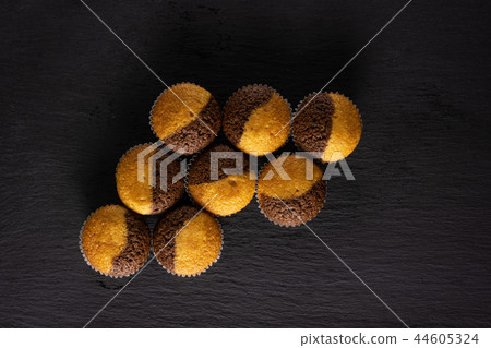 Fresh baked marble muffin on grey stone Fresh baked marble muffin on grey stone 44605324