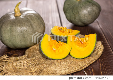 Fresh blue grey pumpkin nagy dobosi on brown wood Fresh blue grey pumpkin nagy dobosi on brown wood 44605578
