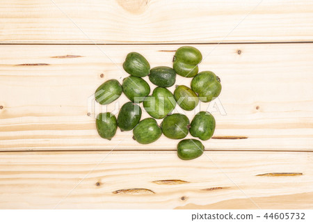 Fresh green mini baby kiwi fruit on natural wood Fresh green mini baby kiwi fruit on natural wood 44605732