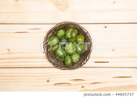 Fresh green mini baby kiwi fruit on natural wood Fresh green mini baby kiwi fruit on natural wood 44605737