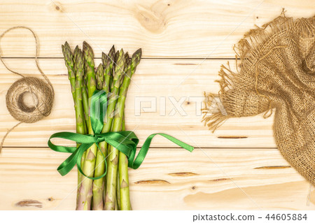 Fresh green asparagus spear on natural wood Fresh green asparagus spear on natural wood 44605884