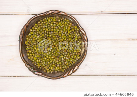 Dry green mung beans on grey wood 44605946