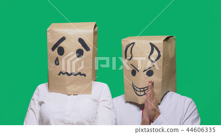 concept of emotion, gestures. a man with a package on his head, with a painted smiley crying, sad 44606335