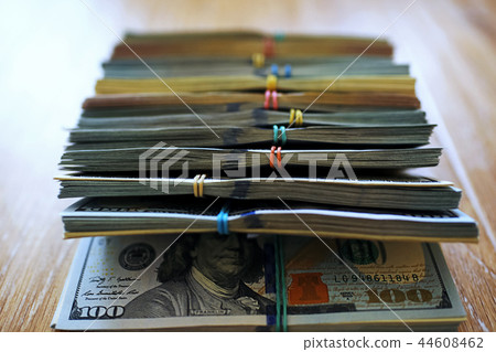 Large bundles of money on the table Large bundles of money on the table 44608462