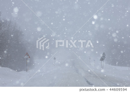 snow and fog on the winter road landscape / view of the seasonal weather a dangerous road, a winter lonely landscape 44609594