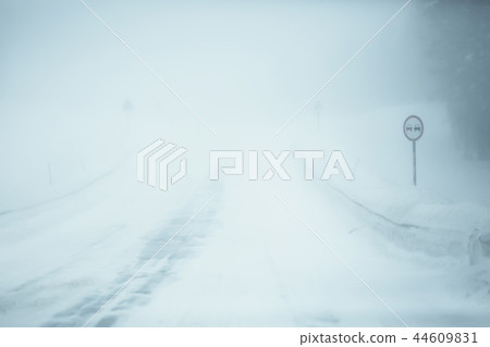 snow and fog on the winter road landscape / view of the seasonal weather a dangerous road, a winter lonely landscape 44609831