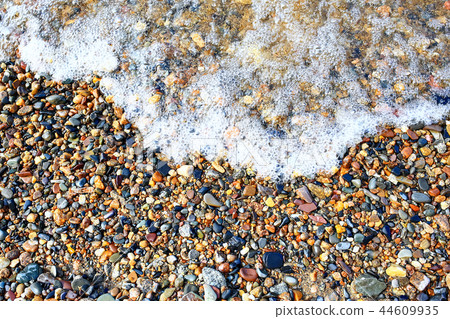 Pebble texture on the river bank 44609935