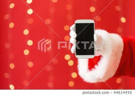 Santa holding a smartphone Santa holding a smartphone 44614450